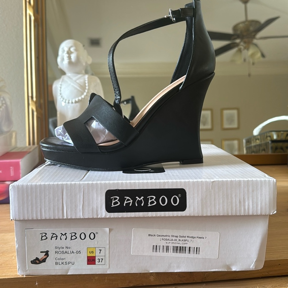 New with tags. Never been worn. Black geometric solid wedge heels. Size 7